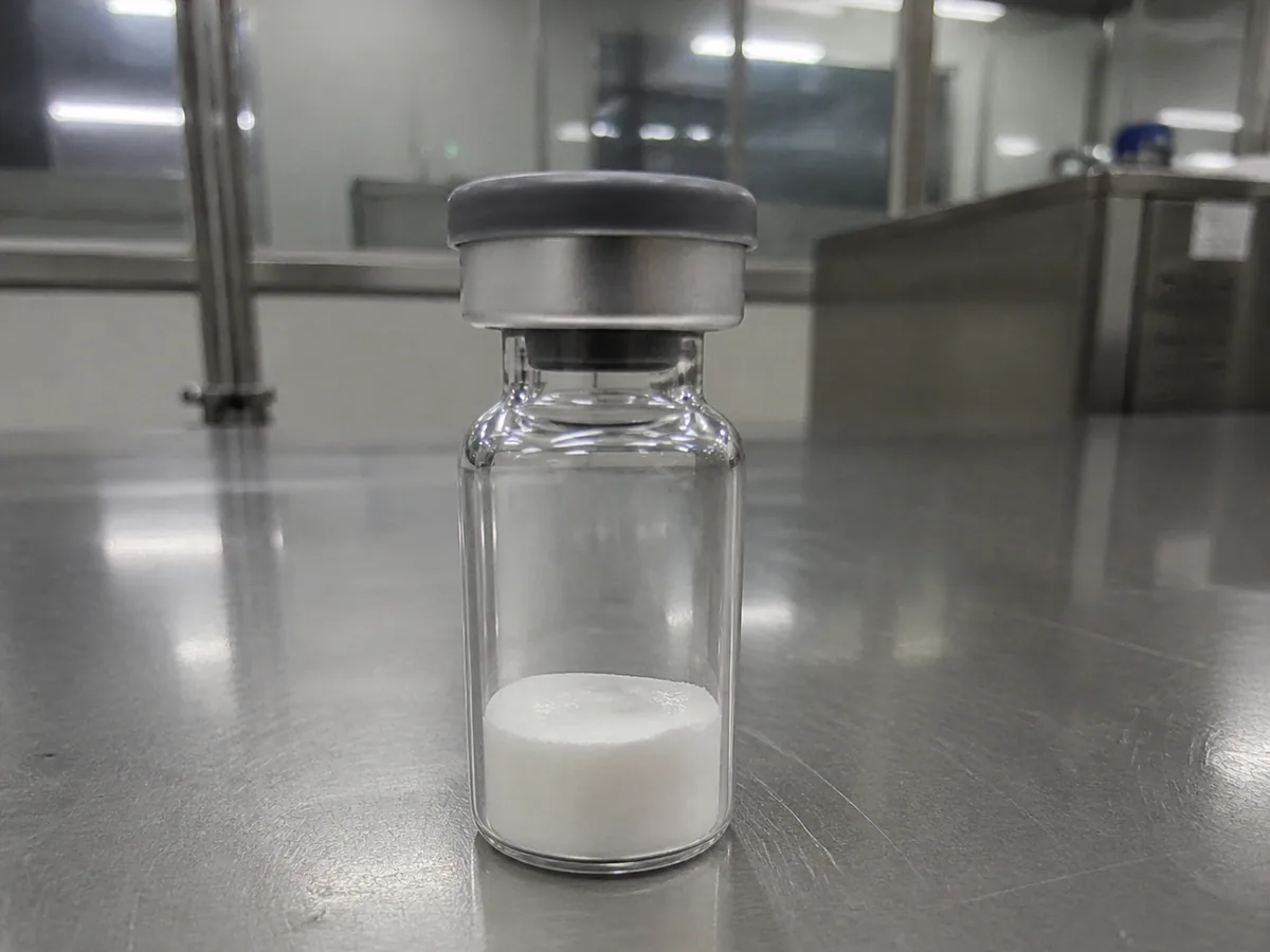 Unlabeled vial with white lyophilized research material